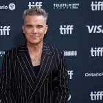 Imagem relacionada a Robbie Williams troca encontros com OVNIs por experiências psíquicas